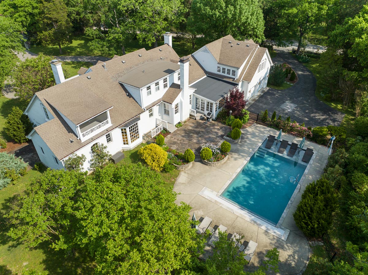 Aerial view of a Middle Tennessee home with a large backyard pool and patio