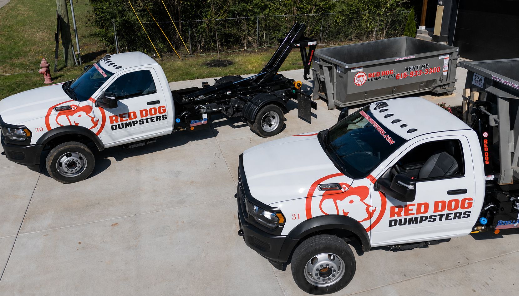 Aerial view of two Red Dog Dumpsters trucks
